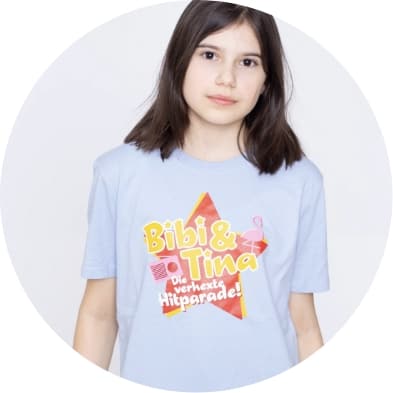 a young girl wearing a blue shirt with a star on it